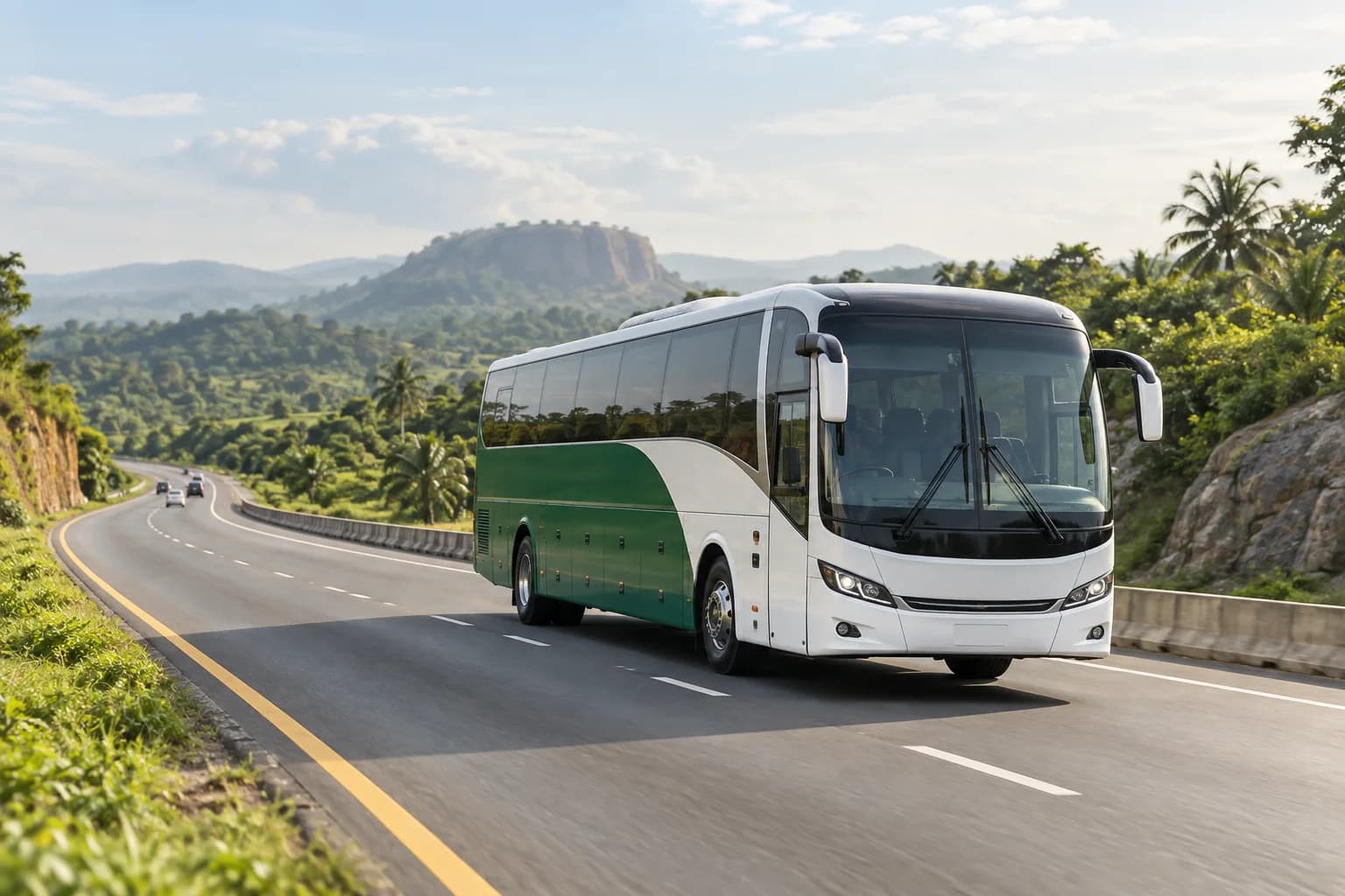 A green and white intercity coach on a highway through a lush Nigerian landscape